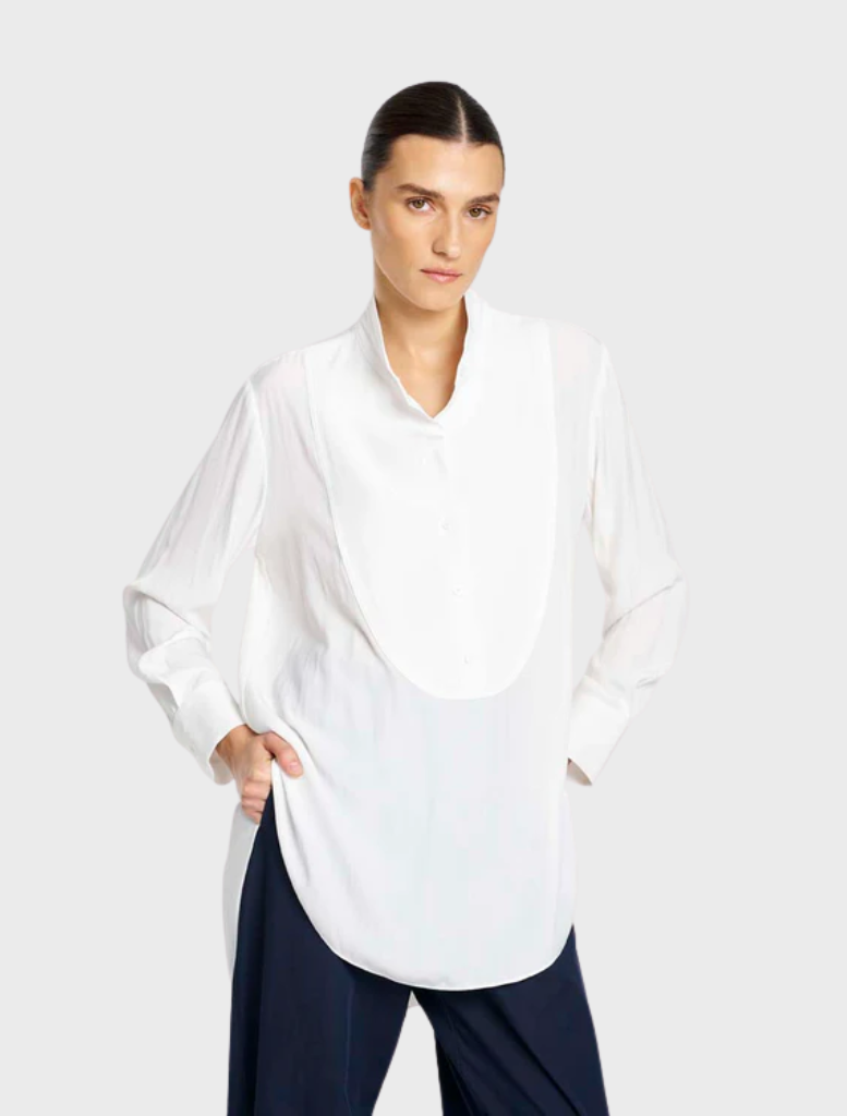 White dinner shirt with a refined collar and long sleeves, presented on a hanger, perfect for upscale dining settings.