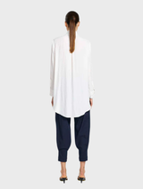 Elegant white dinner shirt with a crisp collar and long sleeves, hanging neatly, ideal for formal dining events.