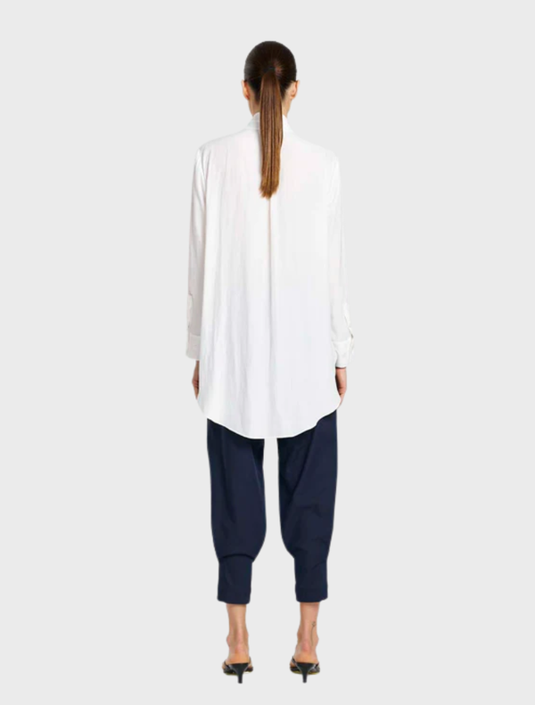 Elegant white dinner shirt with a crisp collar and long sleeves, hanging neatly, ideal for formal dining events.