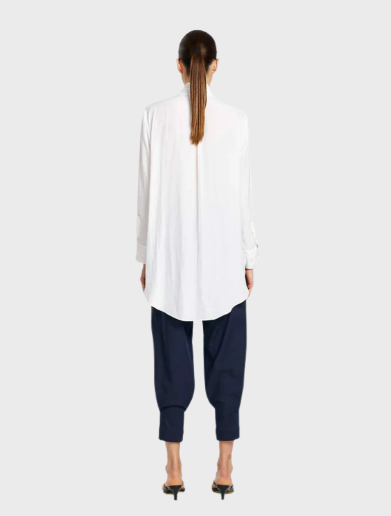 Elegant white dinner shirt with a crisp collar and long sleeves, hanging neatly, ideal for formal dining events.
