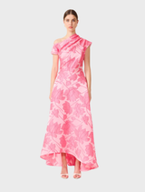 Pink floral asymmetrical maxi gown displayed on a mannequin, showcasing its elegant design and vibrant colors.