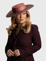 Contemporary rose pink boater hat from Domino Racewear, featuring tonal detailing and an internal cord for secure fit.