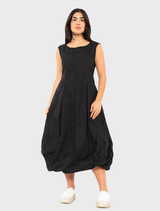Black poplin dress featuring a unique print, showcasing a stylish and modern design suitable for various occasions.