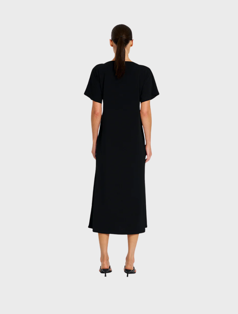 Stylish black dress with a slash neck and short sleeves, designed for a contemporary and elegant appearance.