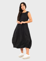 Contemporary black poplin dress with a vibrant print, designed for versatility and fashion-forward looks.