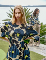 Feminine lime and blue floral dress in satin, featuring balloon sleeves and contrast panels for added elegance and movement.