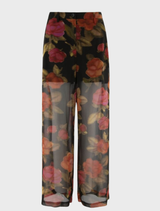 Brown dual trousers displayed on a wooden surface, showcasing their fabric texture and design details.