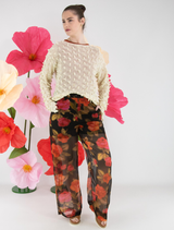 Brown dual trousers displayed on a wooden surface, showcasing their fabric texture and design details.
