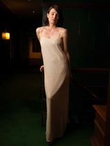 A close-up of a glittery slip dress in Gatsby style, featuring shimmering fabric and elegant design elements.