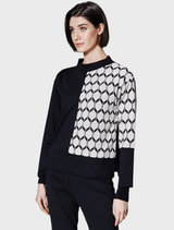 Ecru and black hexagonal jacquard knit fabric featuring a textured geometric design, ideal for stylish apparel.