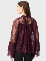 Elderberry lace trapeze top featuring a stand collar, back keyhole, and flounce cuffs for elegant movement and style.