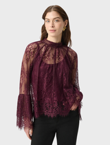 Lace trapeze top in elderberry with scalloped edges, stand collar, and flounce cuffs, offering a graceful silhouette.