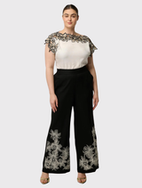 Soft cupro blend ivory top showcasing a wide neckline, cap sleeves, and intricate embroidery for a relaxed yet stylish look.