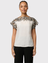 Ivory Eleanor Top designed with a loose fit, cap sleeves, and embroidered shoulders, fashioned from a luxurious cupro blend fabric.