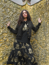 Chic black skirt adorned with gold details, designed to enhance any wardrobe with its playful and fashionable look.