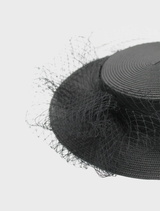 Stylish black boater hat from Danika Racewear, offering a wide brim for sun protection and a trendy appearance.