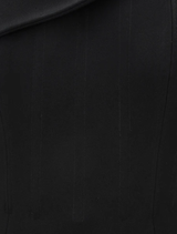 A stunning black Emile gown draped elegantly, highlighting its luxurious fabric and refined style.