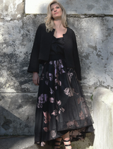 Elegant black skirt with pink accents and a bow, perfect for adding a chic touch to any outfit.