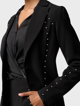 Marcela Pearl's black blazer showcases embellishments, offering a chic and polished appearance for various events.