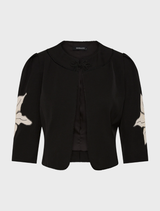 Black Nikita jacket on a mannequin, emphasizing its tailored fit and elegant style.