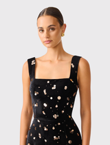 Primelle gown in black and gold, showcasing a fitted silhouette, princess seams, and an exposed back zipper.
