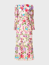 Long sleeve midi dress with a vibrant multi floral pattern, draped gracefully over a display stand.