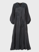 Elegant black dress adorned with sparkles, designed for evening wear, showcasing a fitted style and sophisticated appeal.