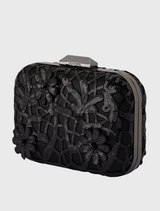 Timeless black appliquéd clutch with sequins, includes a shoulder chain and clasp closure, perfect for holding a smartphone.