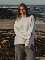 Cream Elevate Mock Merino Cashmere Pullover displayed on a hanger, showcasing its soft texture and elegant design.