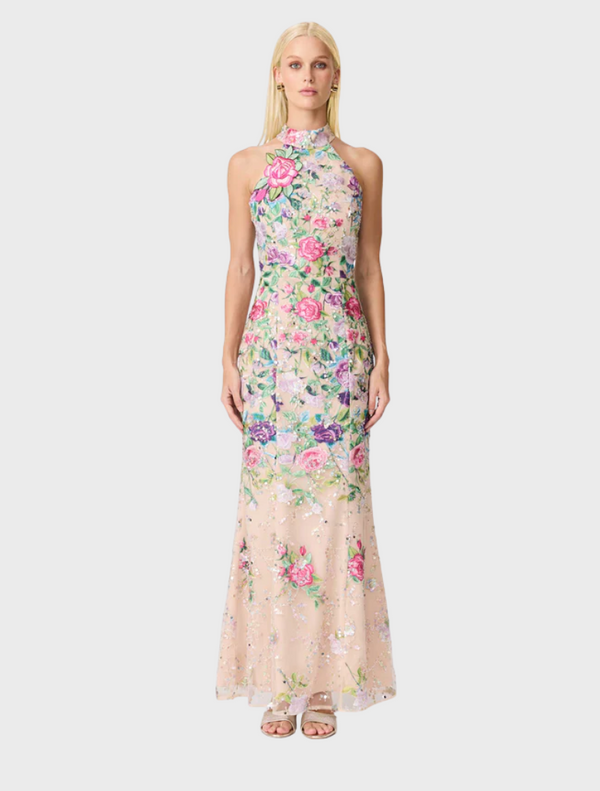 A floral gown featuring a vibrant floral print fabric, showcasing a blend of colors and patterns.