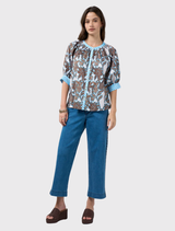 Elegant silk white multi top featuring button closure, shoulder shirring, and contrasting print details on cuffs and collar.