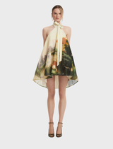 Serene pink halterneck mini dress displayed on a mannequin, showcasing its elegant design and soft color.