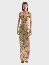Elegant gold Elyse gown with a flowing silhouette and intricate detailing, perfect for formal occasions.