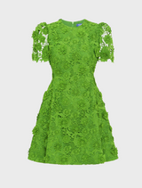 A green dress with a detailed floral pattern, presenting a fresh and stylish look suitable for various occasions.