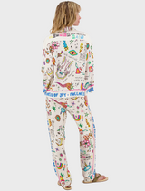  The model wears a cheerful pajama set with an array of colorful designs and patterns.