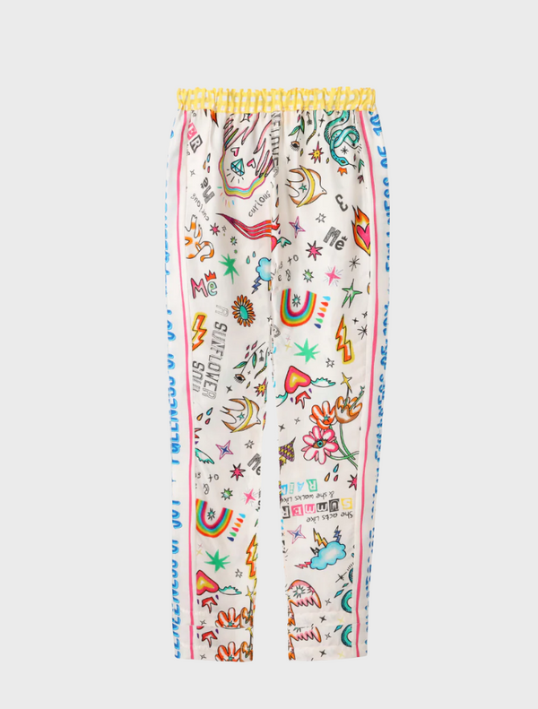 The model displays a stylish pajama set adorned with bright, colorful patterns.