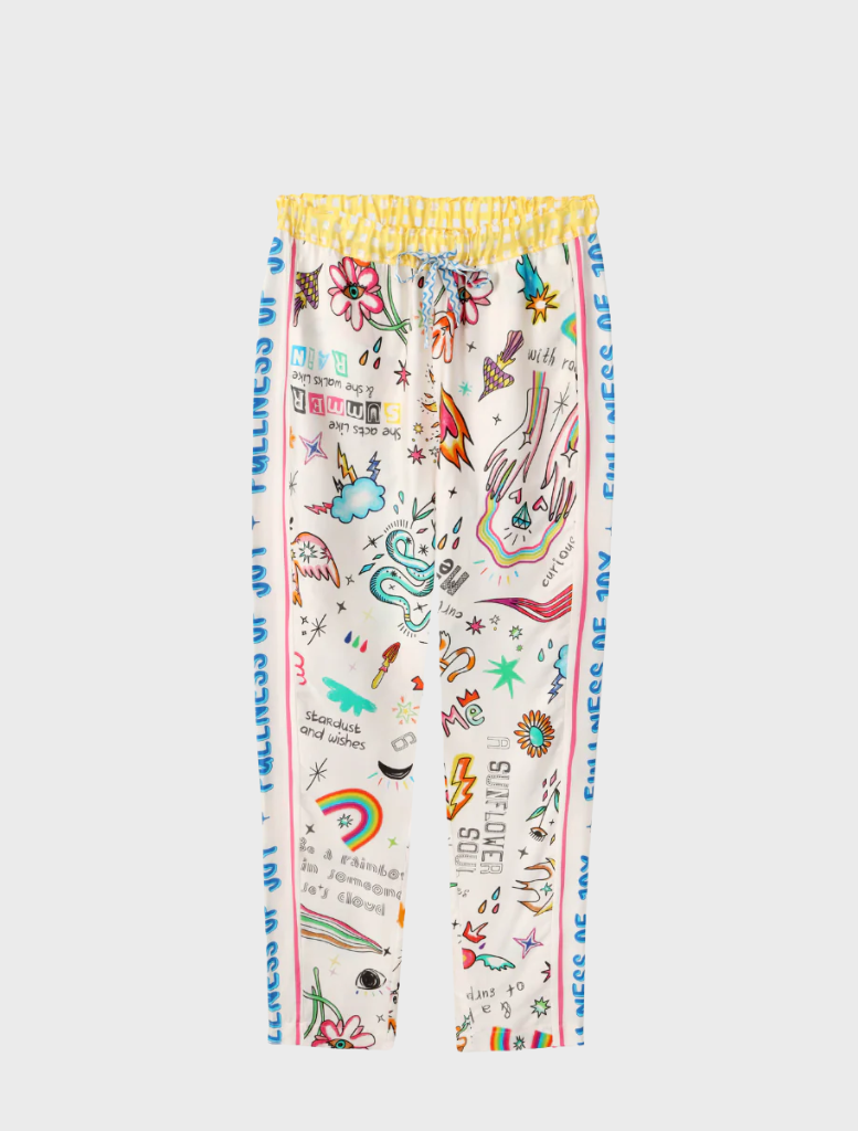 A model is dressed in a colorful pajama set, showcasing playful and vibrant designs.