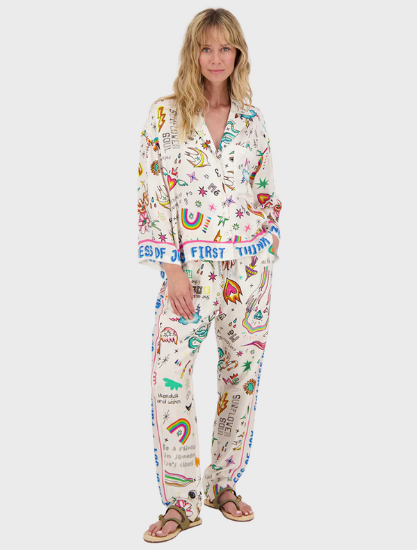  A model showcases a vibrant pajama set featuring colorful designs and patterns.