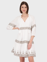 Elegant cream dress with a round neckline, adorned with delicate embroidery designs.