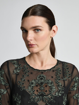 Stylish A-line dress in emerald green and black, offering a versatile look for different occasions and events.