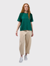 Round neck emerald tee with low raglan seams, linen front and cuffs, and tape detail on the hem and cuffs.