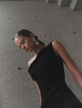 Elegant black Emile gown displayed on a mannequin, showcasing its flowing fabric and sophisticated design.