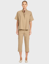 Relaxed fit Tab Shell with short sleeves, button closure at the neck, made from high-stretch Microprene fabric.