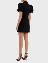 A black and white dress characterized by its trendy puff sleeve.