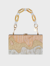 Gold and white handbag featuring a stylish chain strap, elegantly designed for a chic look.