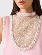 Chic rose pink mini dress with a structured collar and pearl trim, perfect for weddings and cocktail parties.