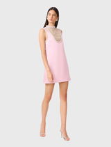 Modern rose pink shift dress with a clean silhouette, sheer neck panel, and pearl embellishments for a sophisticated look.