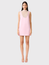 Rose pink mini dress with a structured collar, sheer neck panel, and pearl detailing, ideal for special occasions.