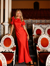 The Scarlet Evangeline Gown showcases a bias-cut silhouette, asymmetric shoulder, and a detachable wrap belt for elegance.