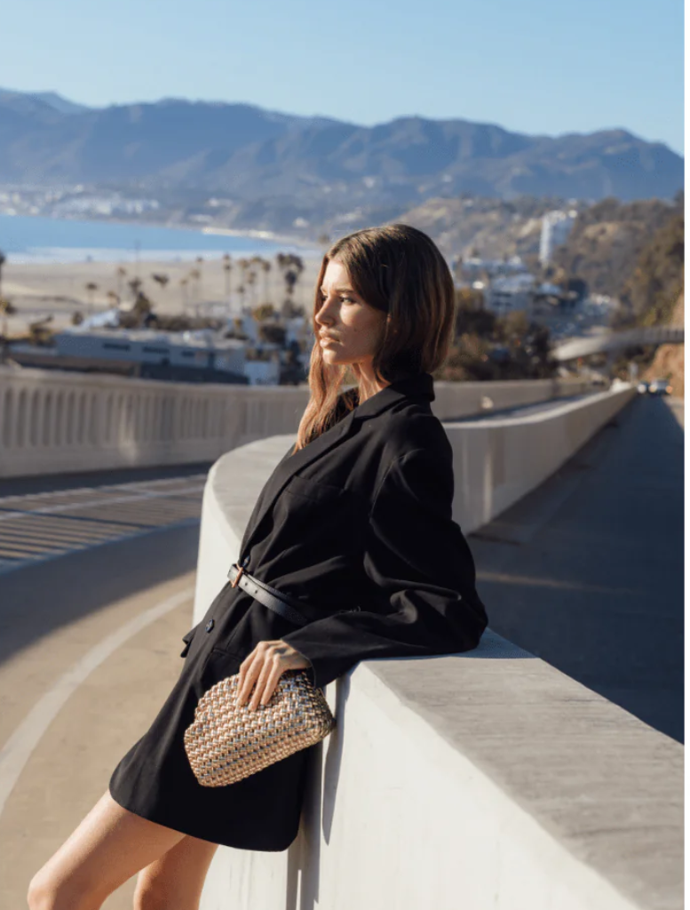 Stylish gold woven clutch bag, constructed from a textured woven material, perfect for formal occasions.